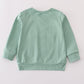 Sage pumpkin french knot top