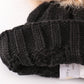 Black pompom cable beanie