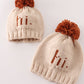 Beige pompom hi cable beanie