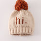 Beige pompom hi cable beanie