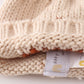 Beige pompom hi cable beanie