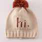 Beige pompom hi cable beanie