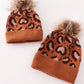 Brown pompom leopard cable beanie