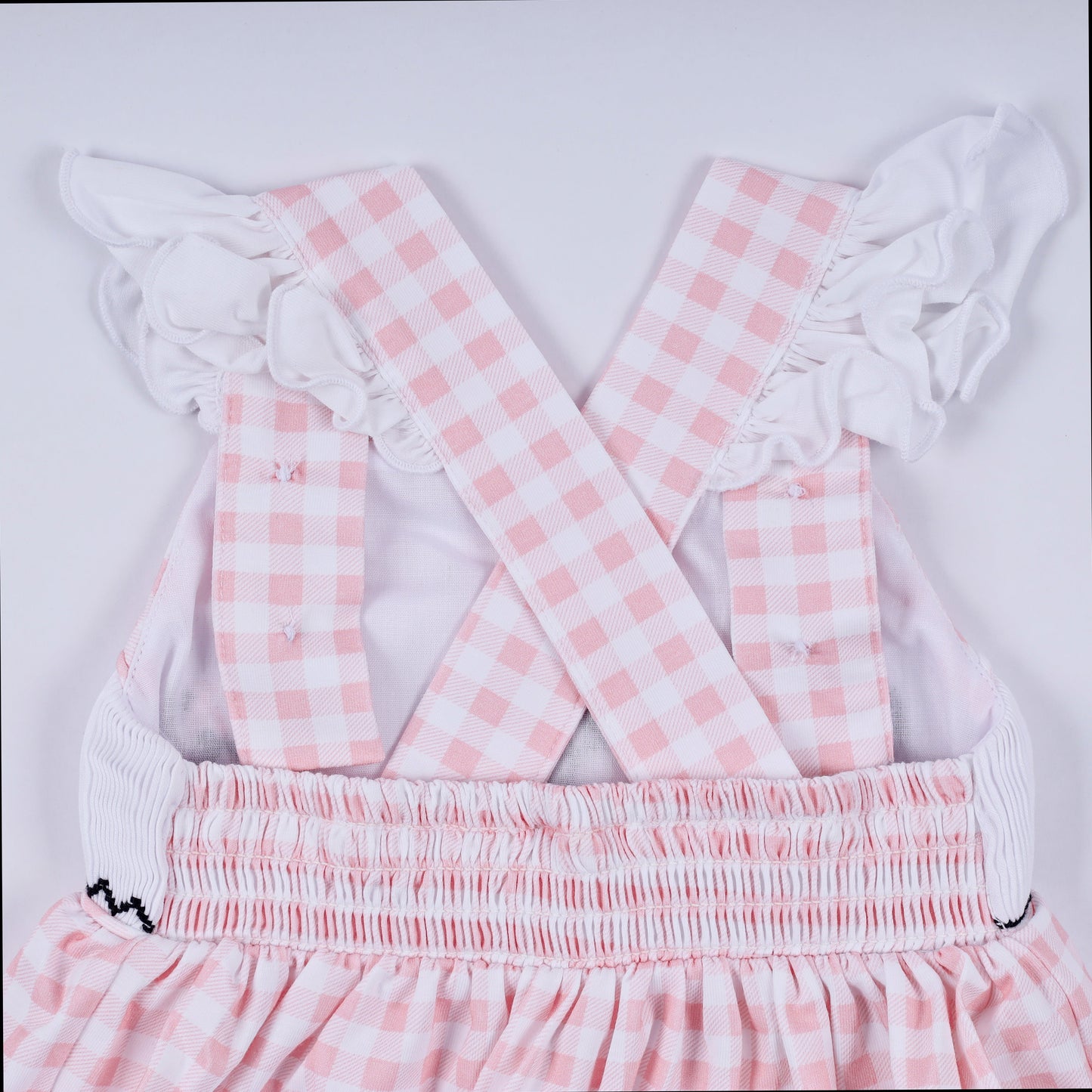 Pink character hand smocked gingham ruffle bubble